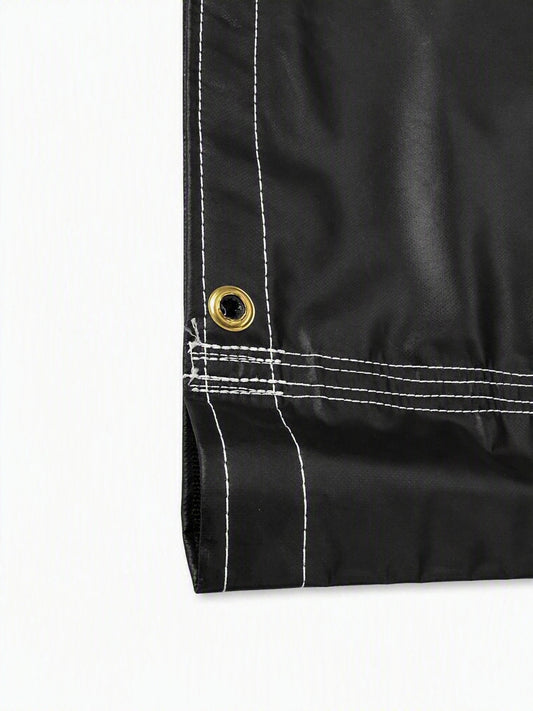 Close-up of a black waterproof fabric corner with white contrast stitching and a brass grommet on a white background.