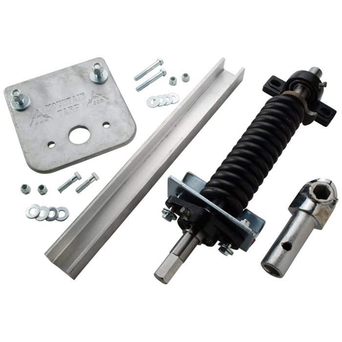 Metal hardware kit including a black coiled spring assembly with mounting bracket, a steel plate with holes, a metal channel bar, bolts, nuts, washers, and a hex-shaped metal connector, arranged on a plain light background.