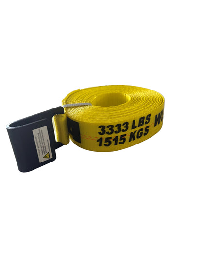 A yellow heavy-duty webbing strap with black printed weight capacity markings ('3333 LBS / 1515 KGS') and a black metal hook, resting on a white textured surface.